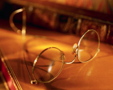 image of reading glasses sitting on a desk